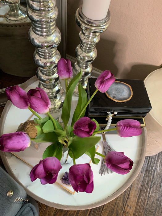 Tulips set in luminescent glass vase